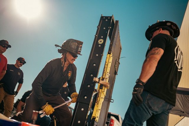 Firefighters practising forcible entry with irons on a door prop